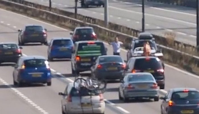 Video: barefoot driver gets out to stop M4 traffic