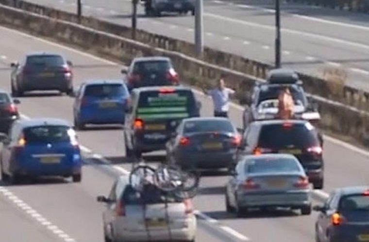 Video: barefoot driver gets out to stop M4 traffic
