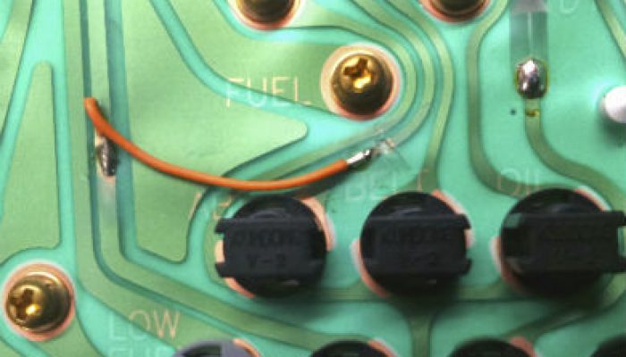 Warning light circuit board bridging hides dangerous defects