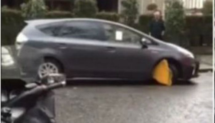 Video: motorist tries to drive off with a clamp on his car
