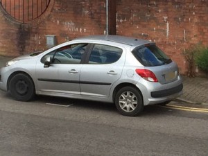 The traffic warden's car, parked on double yellow lines.