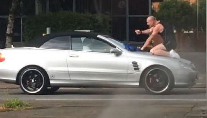 Video: Man climbs on moving Merc to punch and headbutt windscreen