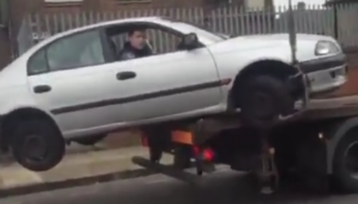 Video: Predictable fail as driver reverses impounded car off truck