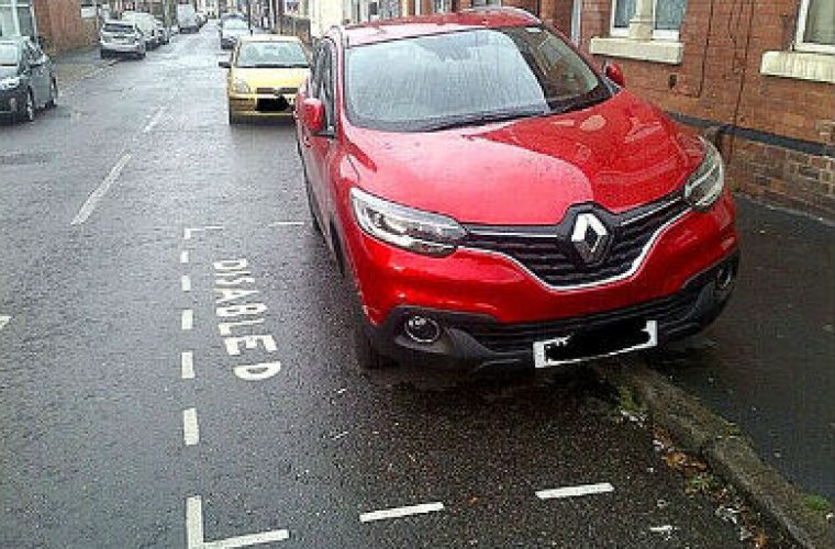 Driver fined for painting blue badge parking bay outside home