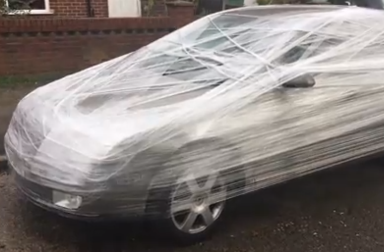 Video: frustrated man cling-films car parked outside his house