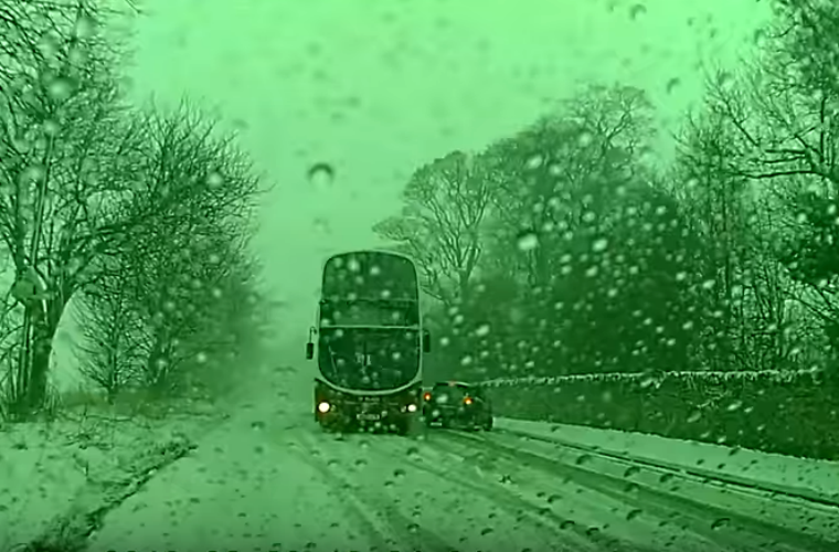 Watch: Skilled bus driver drifts double decker around snow-stricken car to avoid collision