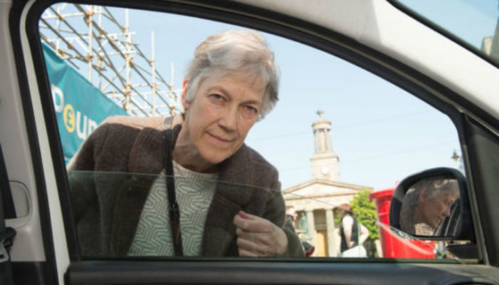 Climate change activist takes to knocking on windows asking drivers to switch off engines