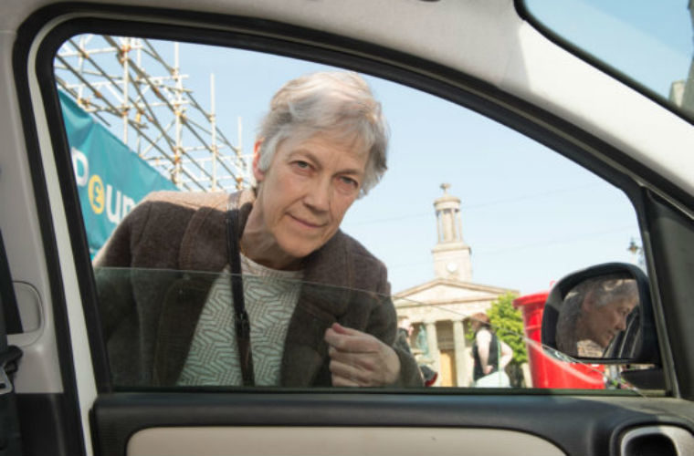Climate change activist takes to knocking on windows asking drivers to switch off engines