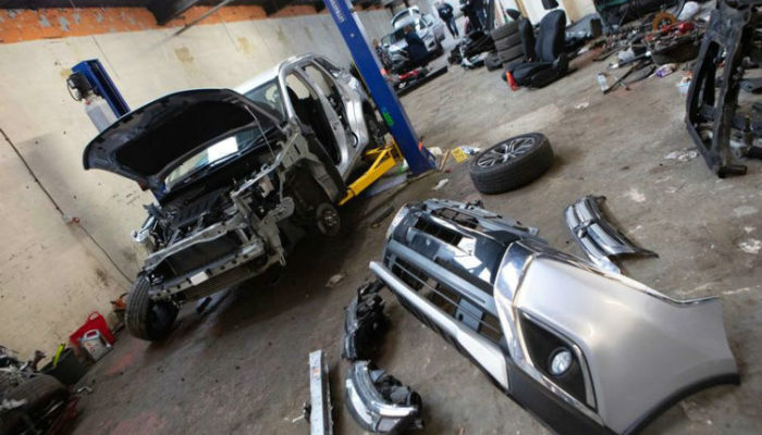 Car parts, cash and suspected stolen cars seized from Manchester workshops