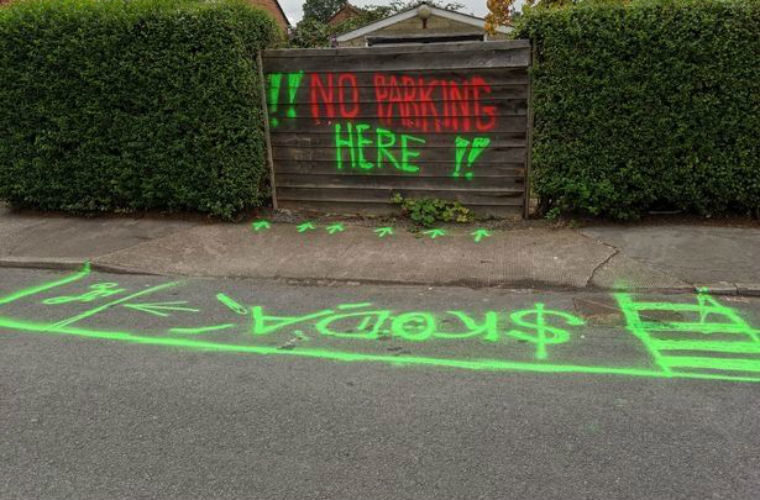 Skoda driver spray paints DIY road markings outside home to reserve space