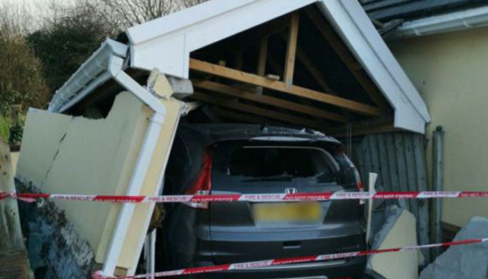 Pair trapped in car as home garage collapses on top of it
