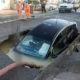 Motorist drives into huge sinkhole