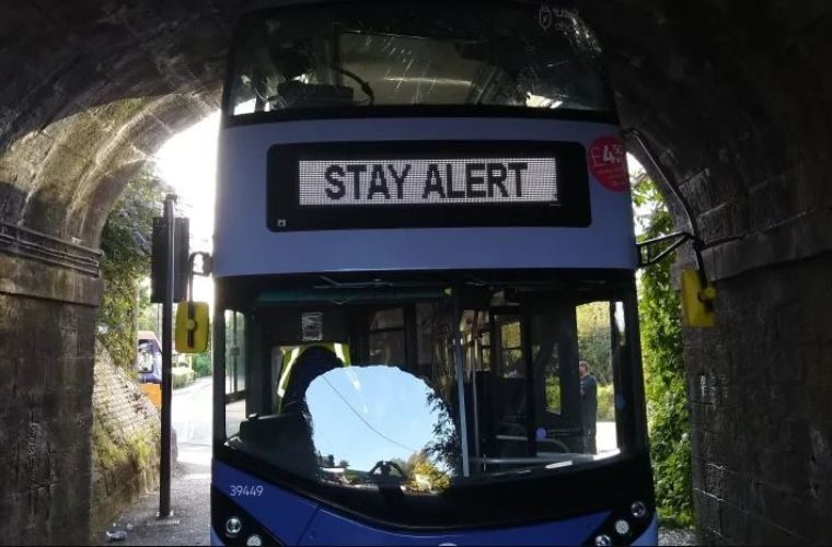 Bus driver ignores ‘stay alert’ public health message and gets stuck under bridge