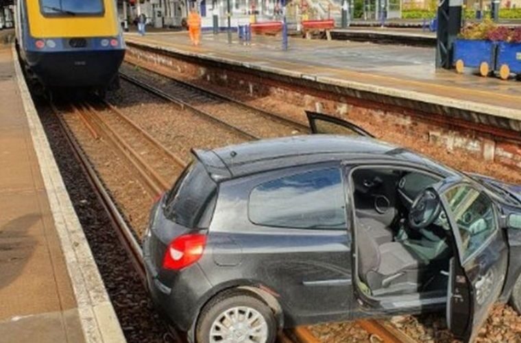 Car lands on rail lines in the Highlands