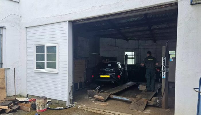 Car plows into Devon garage after motorcycle collision