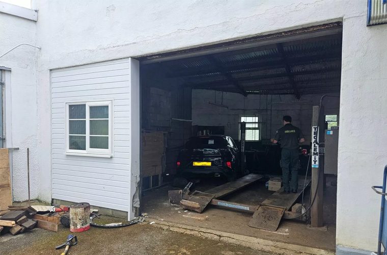 Car plows into Devon garage after motorcycle collision